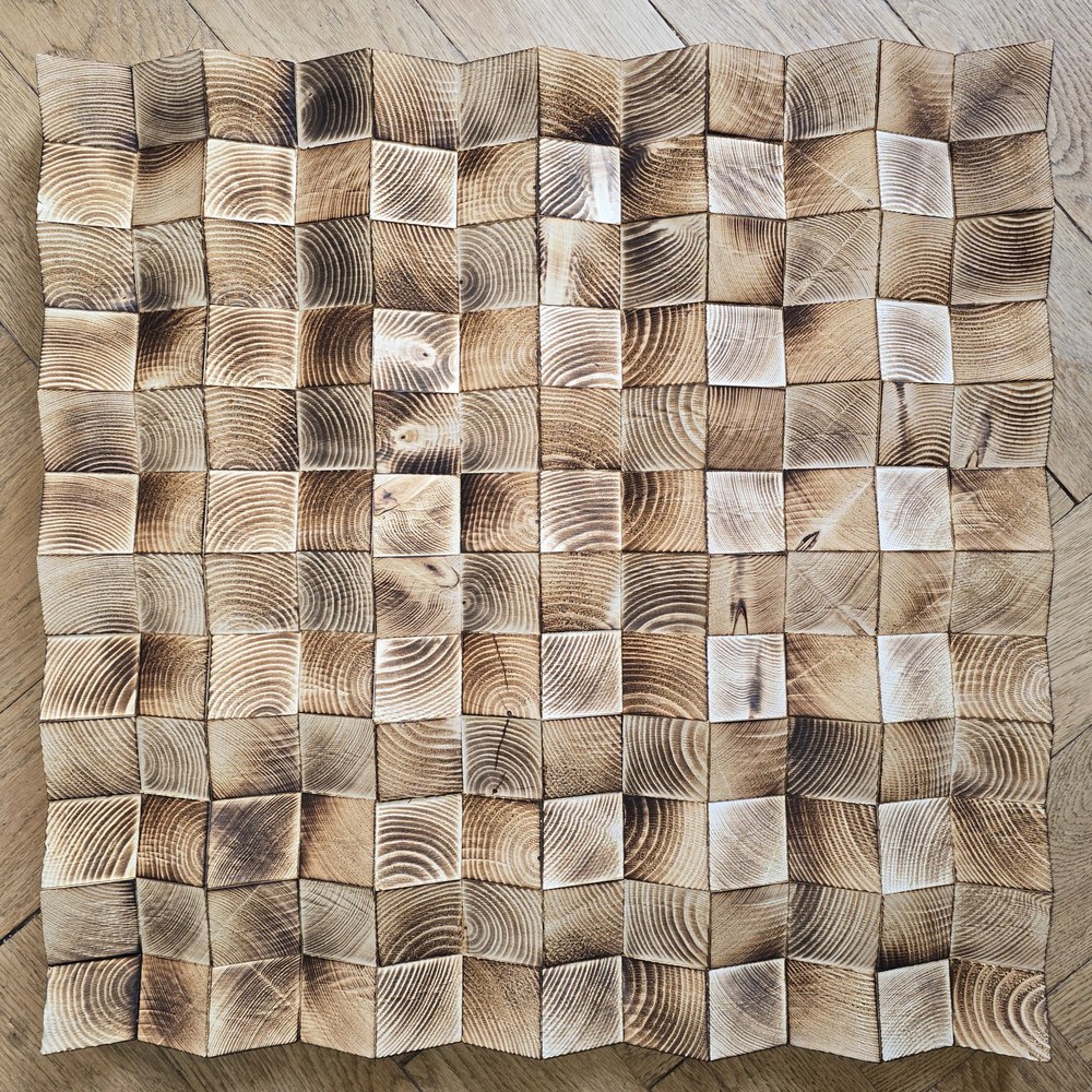 Square wooden wall mosaic with raised geometric blocks and a darkened grain pattern.